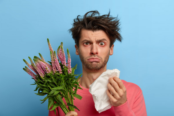 photo-unhappy-sick-young-man-has-problems-with-health-rubs-nose-with-paper-tissue-suffers-from-sneezing-watery-eyes-has-allergy-seasonal-spring-plant-hypersensitivty-blossoming